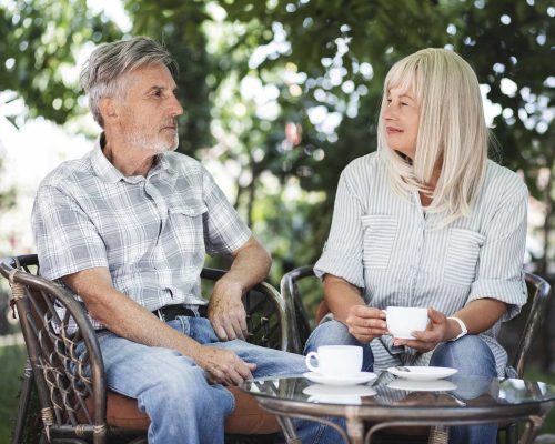 medium-shot-couple-drinking-coffee-outside